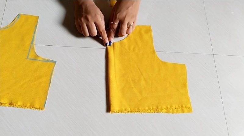 cutting the back portion of yellow cloth