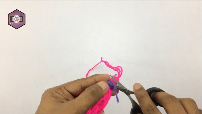 using scissors to cut the thread