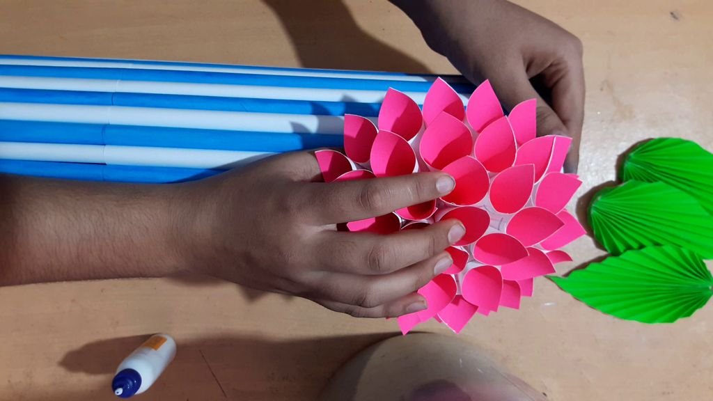 gluing flower on the vase