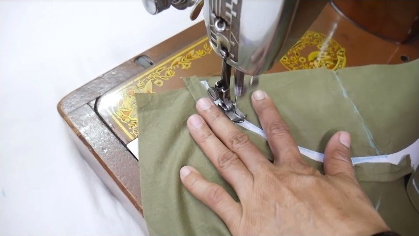 stitching the cloth through the canvas design