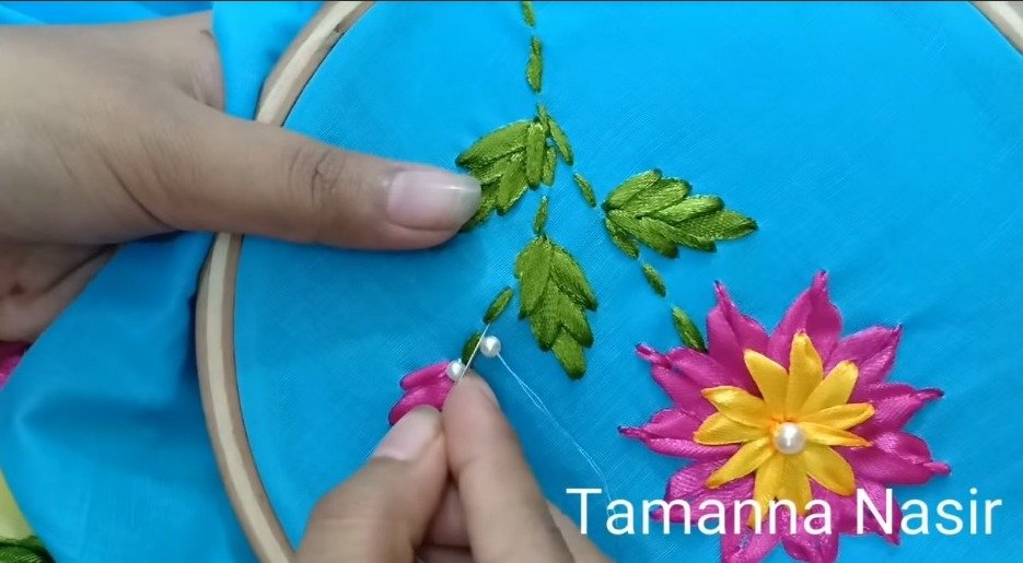 stitching white pearls through branches