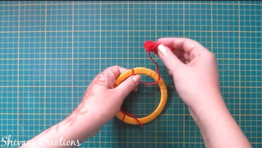 using red thread and make knots in circle